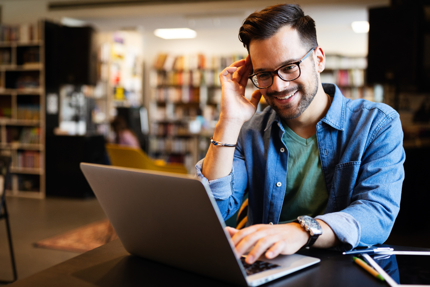 Smiling man at laptop